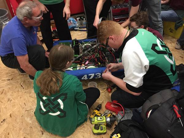 Roving repair crew helping another team with their robot