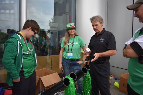 President of FIRST Robotics Canada, Mark Breadner, engaging with our t-shirt cannon, Lola, at IBM Canada's 100 year anniversary barbeque