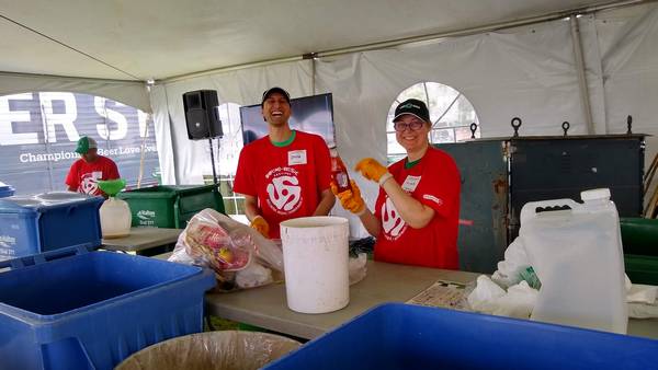 Two of our mentors sorting garbage and recyclables to divert Sound of Music Festival waste from the dump