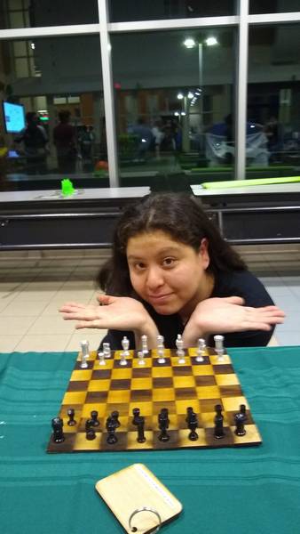 One of our mentors posing with her custom gift — a chess set manufactured by the students