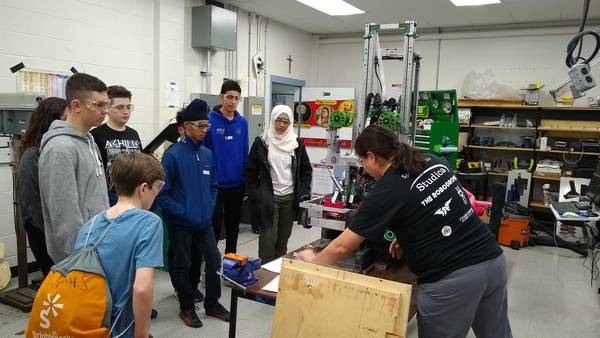 Showing new students our shop and 2018 robot, Tipsy