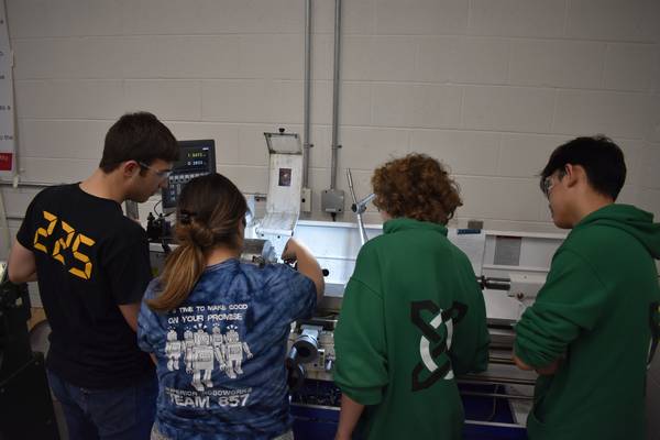 Group of Celt-X students using the lathe